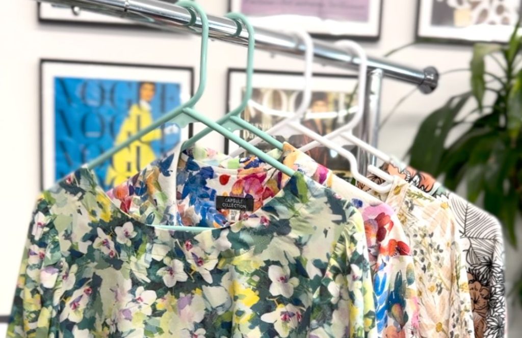 Peek at capsule wardrobe hanging on clothing rack